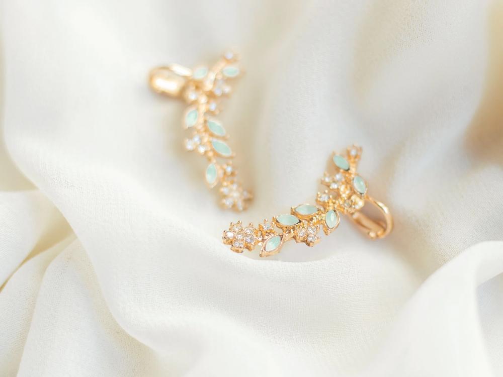 gold earrings on white organza 
